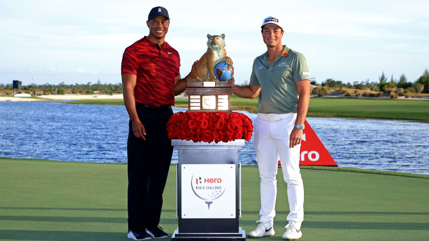 NASSAU, BAHAMAS - DECEMBER 05: Tiger Woods of the United States poses with Viktor Hovland of Norway and the trophy after winning the Hero World Challenge at Albany Golf Course on December 05, 2021 in Nassau, . (Photo by Mike Ehrmann/Getty Images)