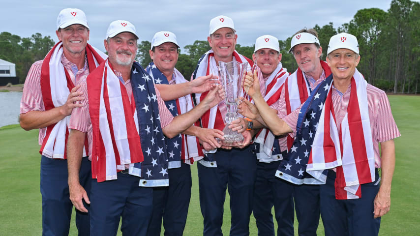 BRADENTON, FLORIDA - DECEMBER 10: Team USA Captain Jim Furyk holds the World Champions Cup trophy with the rest of his team on the 18th hole during day three of afternoon singles matches at the World Champions Cup at The Concession Golf Club on December 10, 2023 in Bradenton, Florida. (Photo by Ben Jared/PGA TOUR via Getty Images)