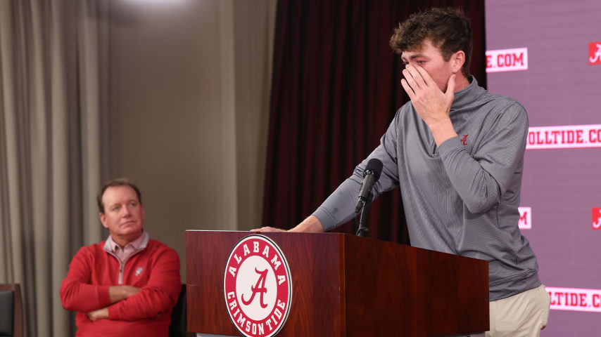 Alabama golf coach Jay Seawell looks on as Nick Dunlap gets emotional during his press conference Thursday. (Haley Peterson/PGA TOUR)