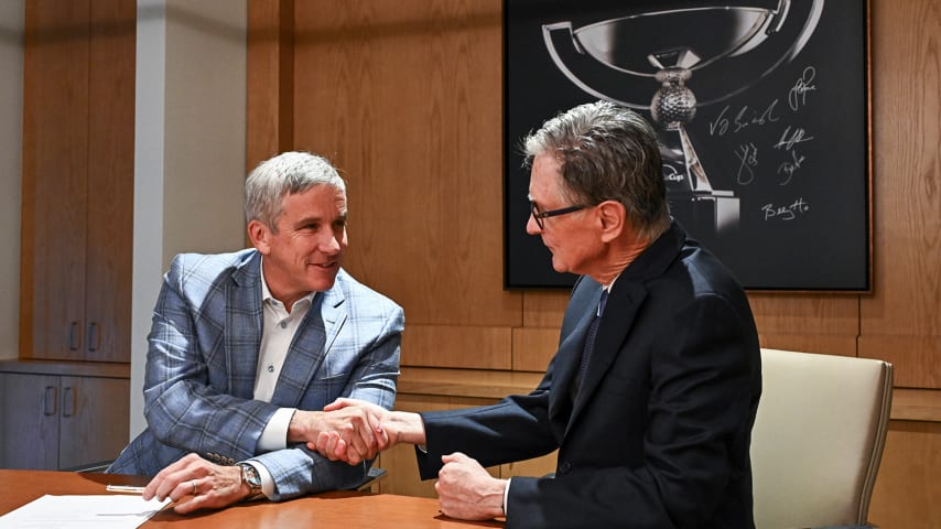 PGA TOUR Commissioner Jay Monahan (left) and John W. Henry, Principal Owner of Fenway Sports Group and Manager of the Strategic Sports Group, finalize the launch of PGA TOUR Enterprises. (Chris Condon/PGA TOUR)