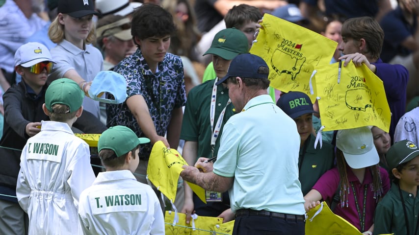 Two-time Masters winner Tom Watson signs for the patrons at the Masters Par 3 Contest. (Ben Jared/PGA TOUR)