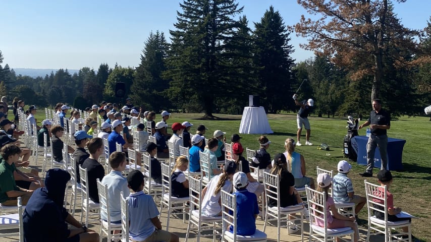 Nick Taylor hits golf balls in front of kids at Ledgeview Golf Club. (Courtesy of Ledgeview Golf Club)