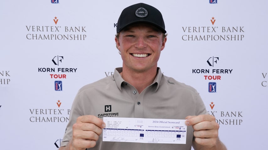 Frankie Capan III poses for a photo with his scorecard after completing his first round of the Veritex Bank Championship. His round of 58 set a new course record. (Sam Hodde/Getty Images)