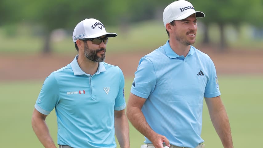 Adam Hadwin (left) of Canada and Nick Taylor of Canada speak on the fourth green during the third round of the Zurich Classic of New Orleans at TPC Louisiana on April 27 in Avondale, Louisiana. (Jonathan Bachman/Getty Images)