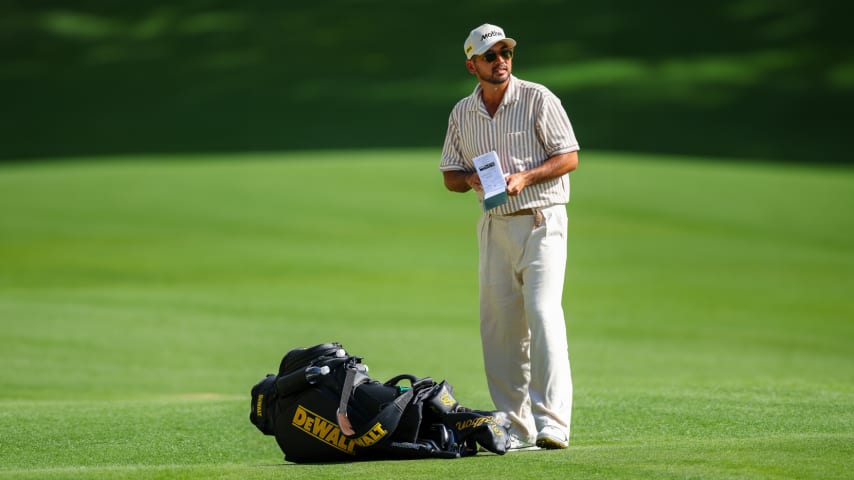 Jason Day looks over an upcoming approach shot on the 18th hole during the second round of the Wells Fargo Championship. (Andrew Redington/Getty Images)