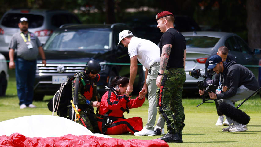 Andie Taylor (in red), wife of Nick Taylor (in white) lands a tandem skydive with the Canadian Forces Parachute Team. (Vaughn Ridley/Getty Images)