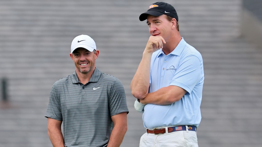 Rory McIlroy and Peyton Manning meet on the second hole during the pro-am prior to the Memorial Tournament presented by Workday. (Michael Reaves/Getty Images)