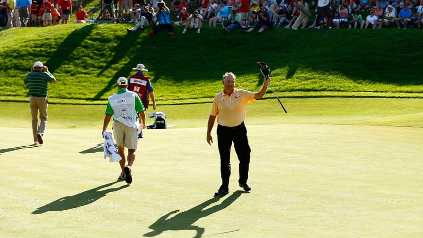 Ken Duke waves to the crowd after finishing the 18th hole during the final round of the 2013 Travelers Championship.  (Jared Wickerham/Getty Images)