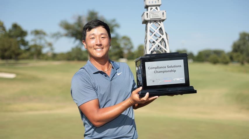 John Pak poses for a photo with the trophy after winning the Compliance Solutions Championship. (Andrew Wevers/Getty Images)