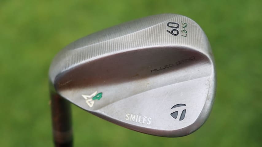 Miles Russell's TaylorMade MG4 60-degree wedge stamped with "Smiles". (GolfWRX)