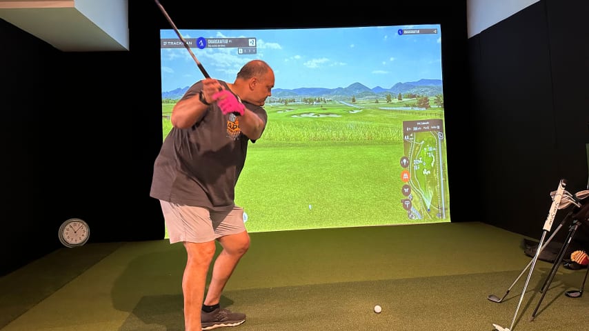 Omar Ghaffar hitting into golf simulator. (Courtesy Scott Gutterman/PGA TOUR)