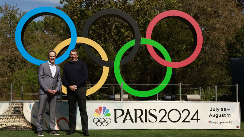 Dan Hicks of NBC (L) and Antony Scanlon (R) pose for a photo in front of the Olympic rings at TPC Sawgrass during THE PLAYERS Championship. (Jason Miczek/PGA TOUR)