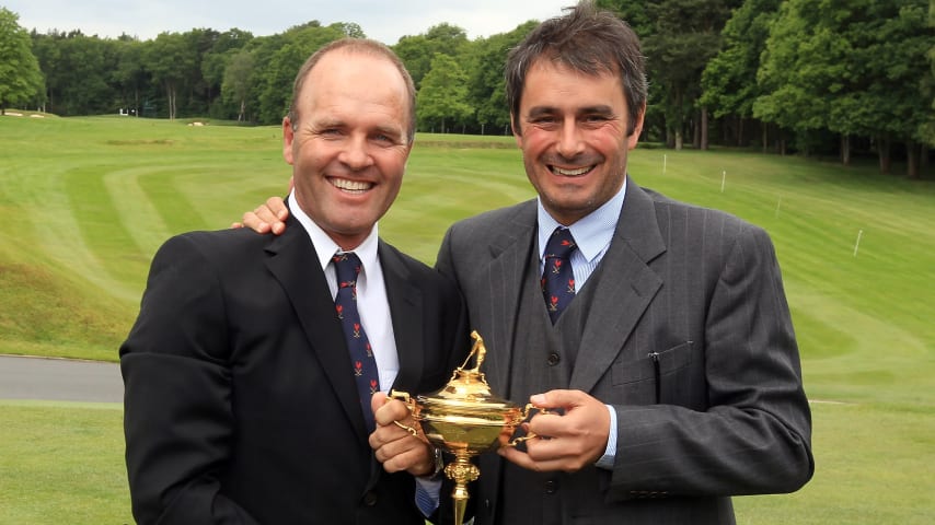 Thomas Levet and Jean Van de Velde of France, past Ryder Cup players, proudly hold the Ryder Cup. (David Cannon/Getty Images)