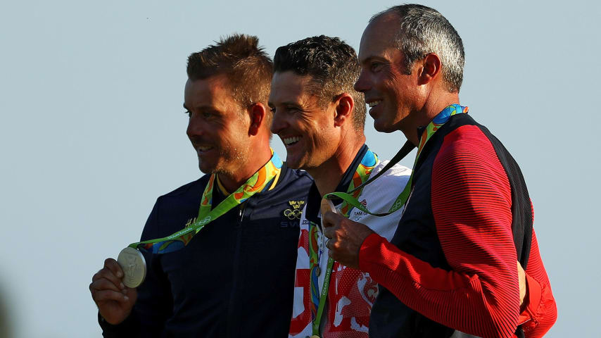 Justin Rose (C) of Great Britain celebrates with the gold medal, along with Henrik Stenson (L) of Sweden, silver medal, and Matt Kuchar of the United States, bronze medal, at the 2016 Olympic Games. (Scott Halleran/Getty Images)