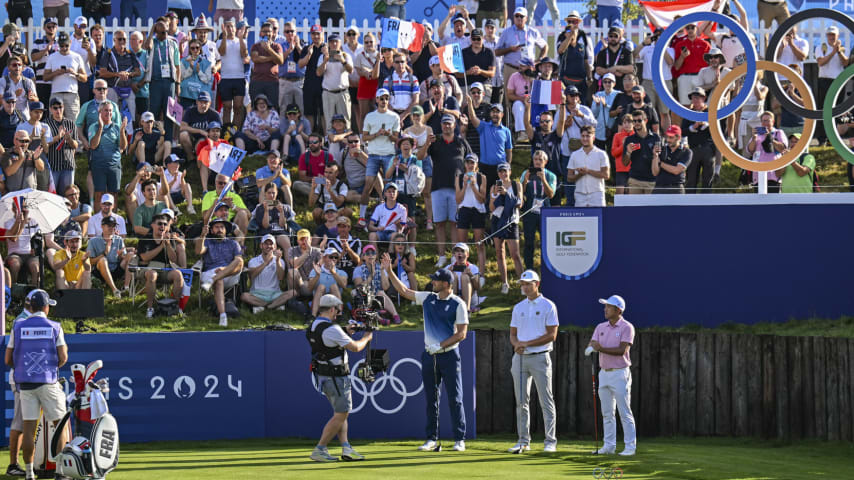 Victor Perez of Team France acknowledges fans waving French flags on the first tee during the first round of the Olympic men’s golf competition. (Keyur Khamar/PGA TOUR)