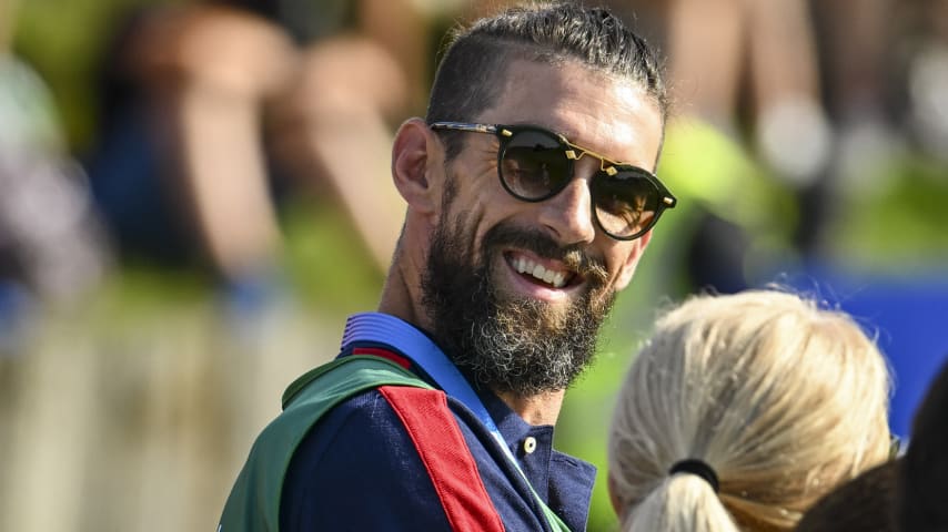 Former Olympic athlete Michael Phelps smiles on the first tee during the first round of the Olympic men's golf competition at Le Golf National. (Keyur Khamar/PGA TOUR)