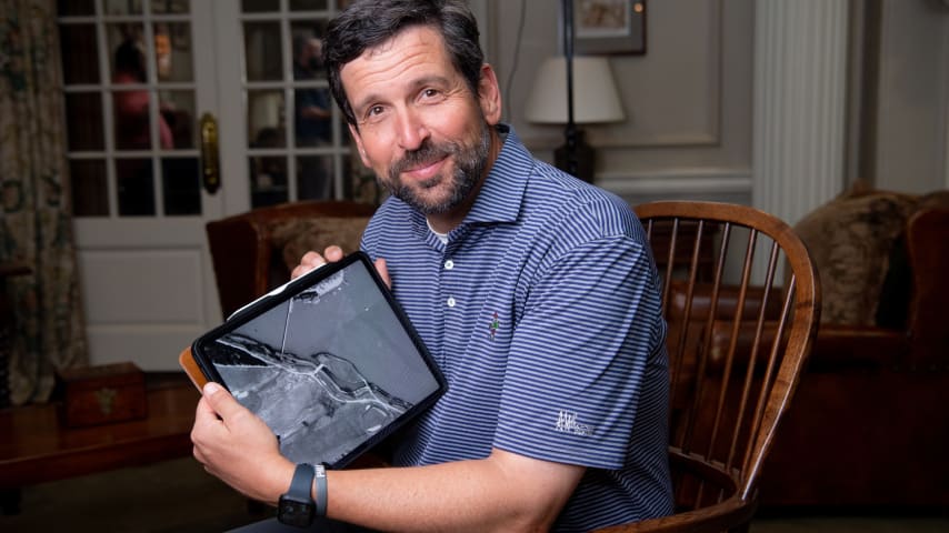 Andrew Green posing with the 1949 aerial of East Lake Golf Club. (Kate Awtrey)