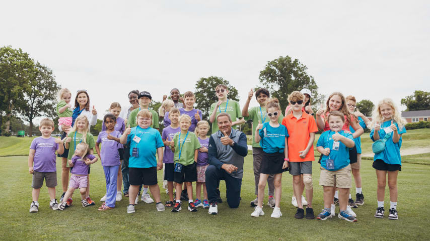 Dan Houston, chairman, president, and chief executive officer of Principal Financial Group®, and wife Joanie Houston, pose with Principal Charity Classic tournament charity partner youth champions following opening ceremonies at Wakonda Club. (Principal Charity Classic)