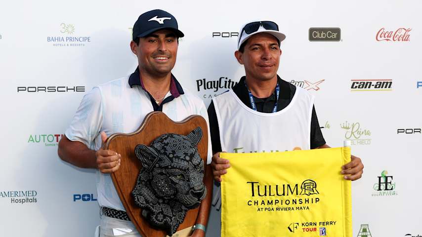 Bryson Nimmer poses with the trophy and his caddie after winning the 2025 Tulum Championship at PGA Riviera Maya. (Luke Hales/Getty Images)
