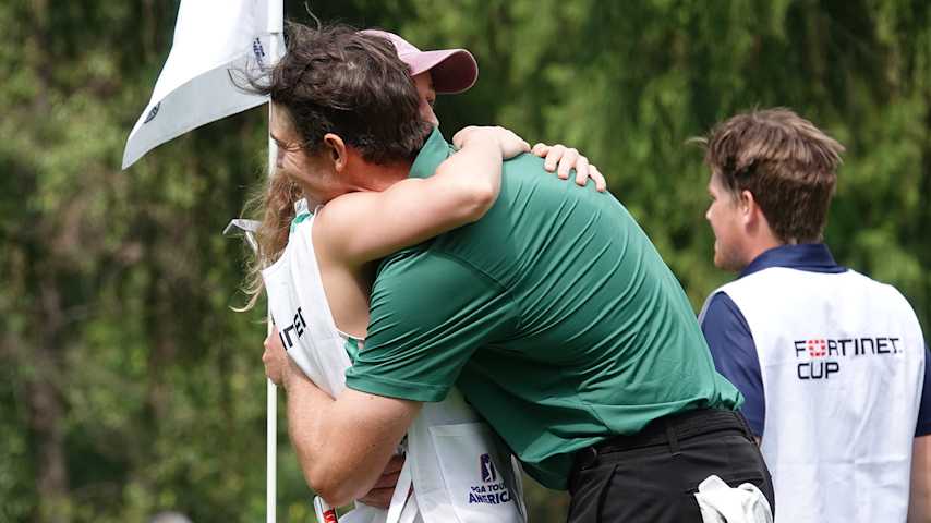 Butler hugs girlfriend Demi, his caddie at the Bupa Championship, following a win that took to the top of the Fortinet Cup standings. (Gregory Villalobos/PGA TOUR Americas)