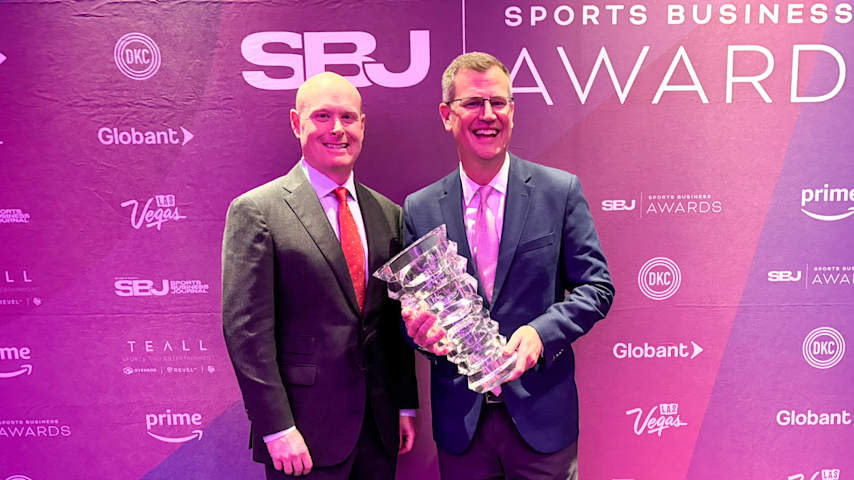 PGA TOUR's Andy Weitz (left) and Strategic Sports Group's Sam Kennedy (right) holding the “Deal of the Year” award at the 2025 Sports Business Awards. (PGA TOUR)