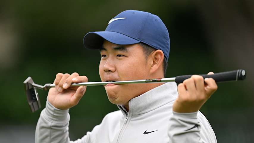 Tom Kim bites his putter at the 2025 AT&T Pebble Beach Pro-Am. (Ben Jared/PGA TOUR)