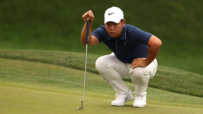 Tom Kim lines up his putt at THE PLAYERS 2025. (Richard Heathcote/Getty Images)