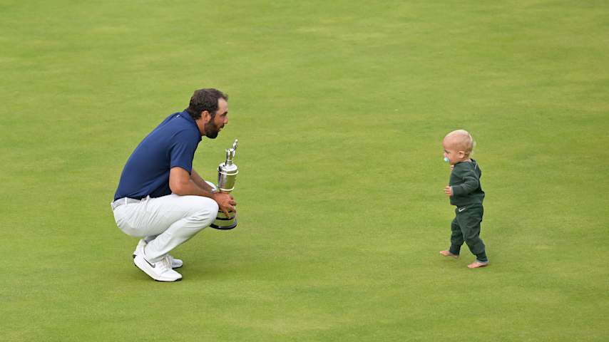Scottie Scheffler celebrates with his son Bennett Scheffler and the Claret Jug on the 18th green after winning The 153rd Open Championship at Royal Portrush Golf Club in Portrush, Northern Ireland. (Ben Jared/PGA TOUR)