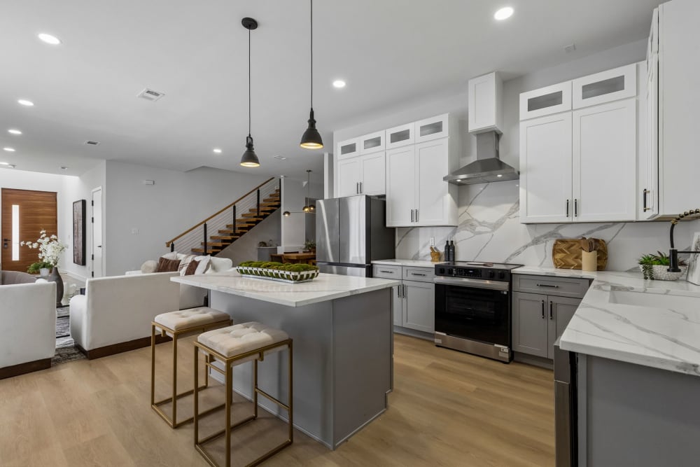 Quartz kitchen island with dual-tone soft-close cabinetry at 816 Premier Parkway