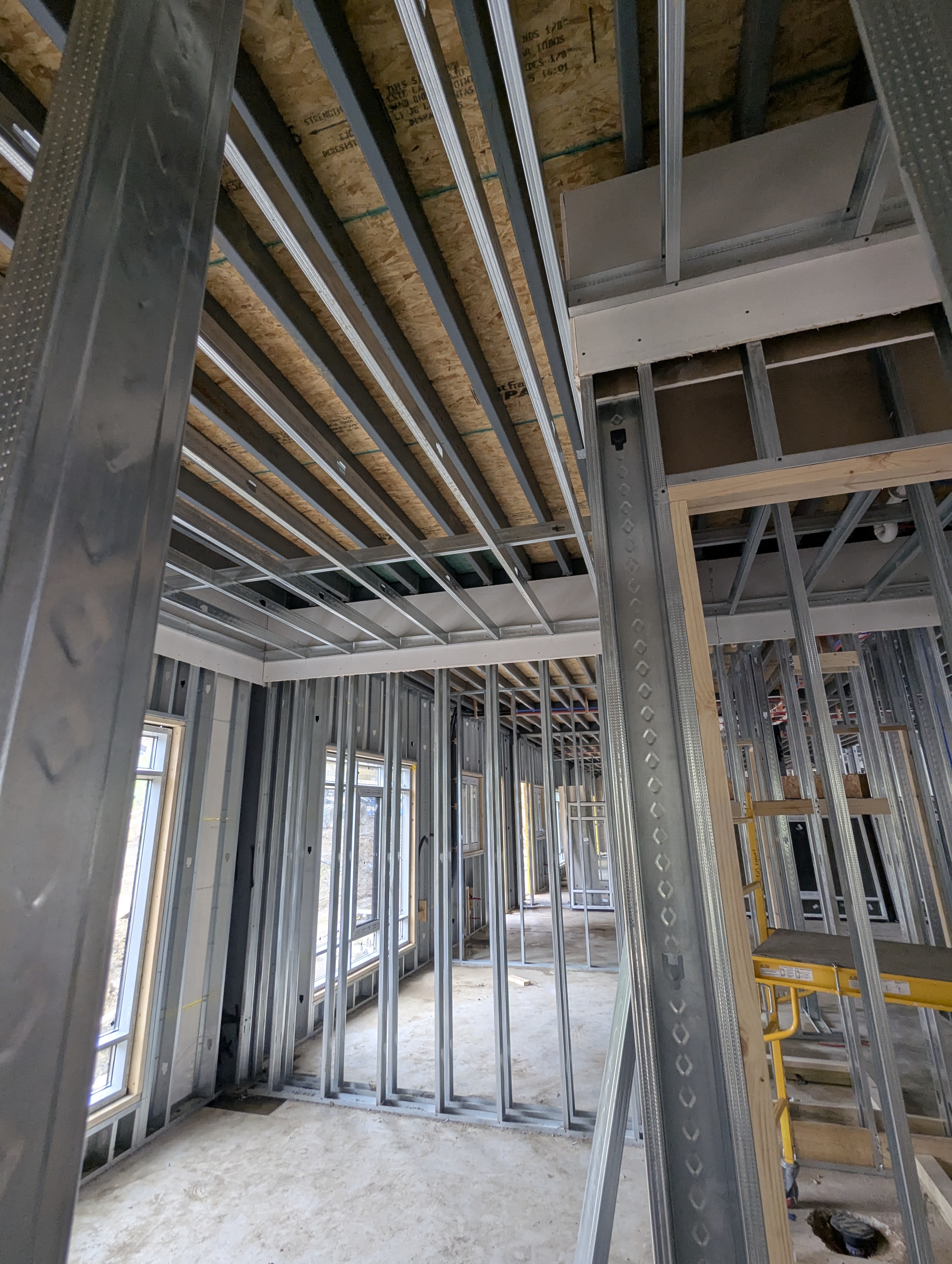Upward view of steel framing, illustrating the dimensional consistency steel holds from first frame to final finish