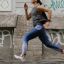 A Side View of a Woman Jogging on the Street