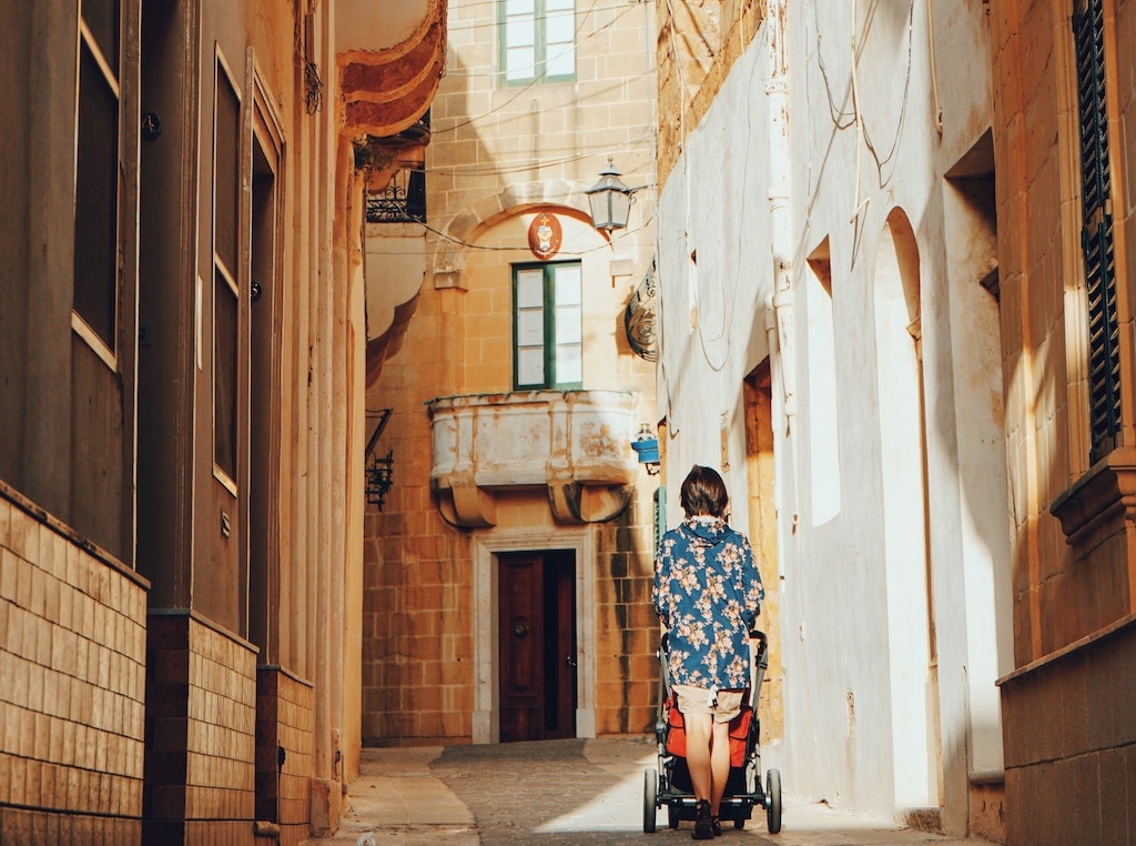 Women pushing pram.