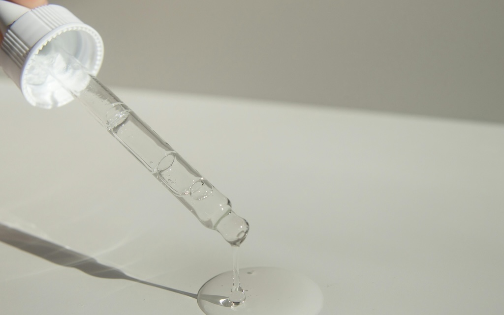 Person pouring liquid product with pipette