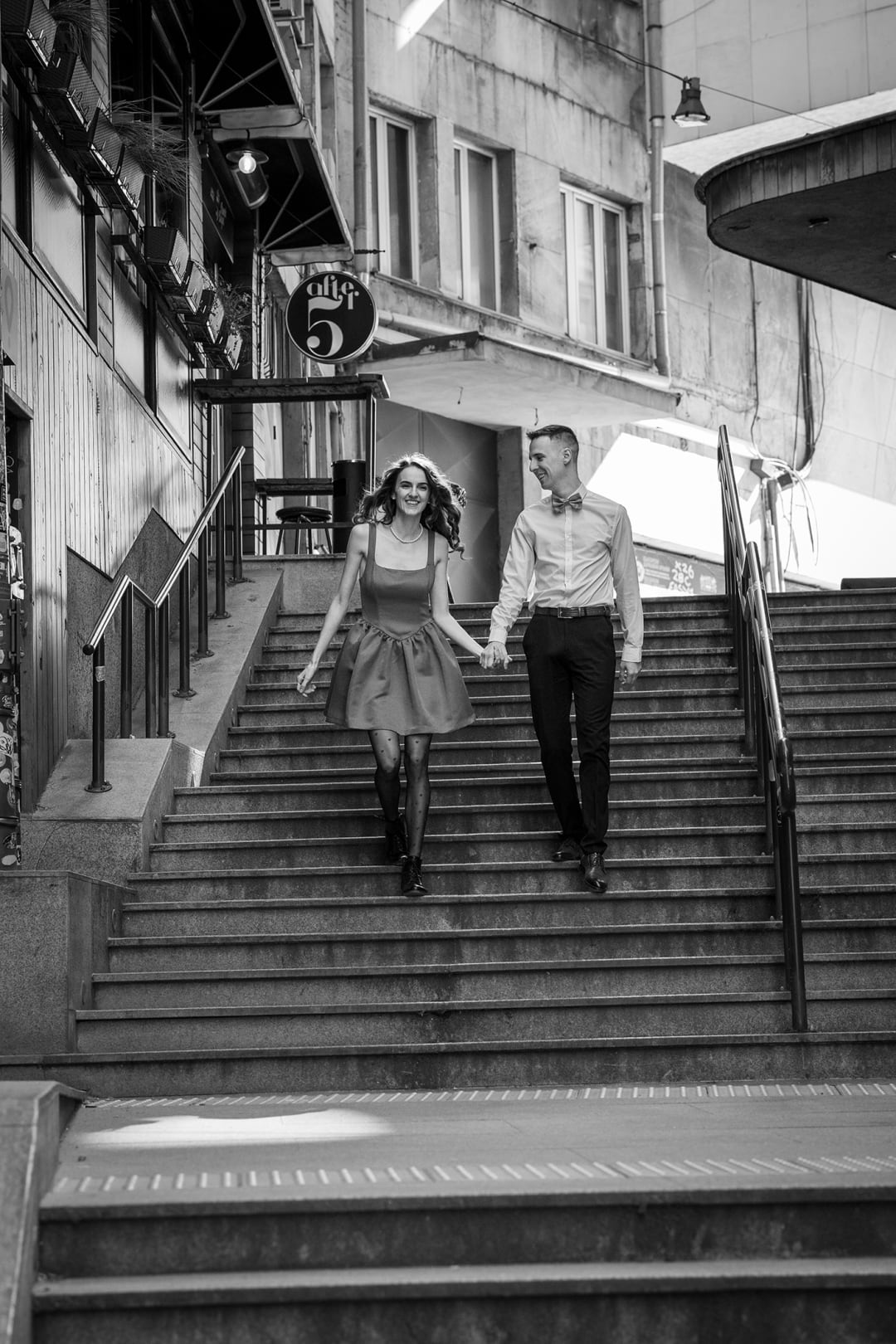 Couple walking down stairs in an urban environment