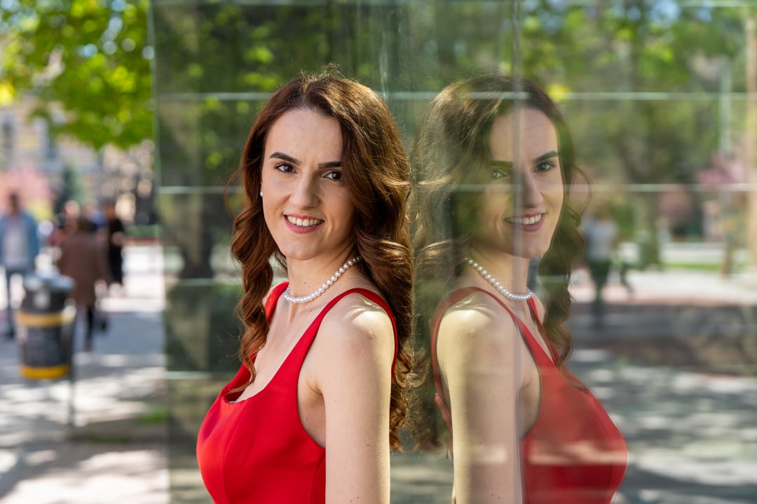 Photo of a woman reflected in a glass wall