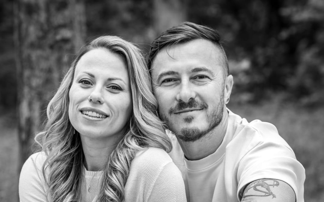 A photo of a couple in love posing next to each other.