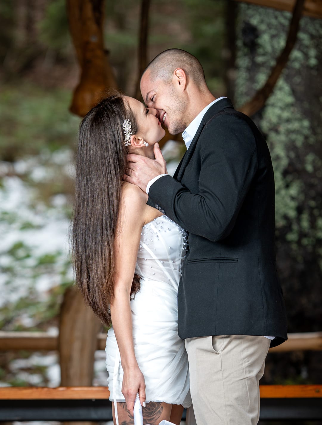Couple kissing under a canopy in the snow