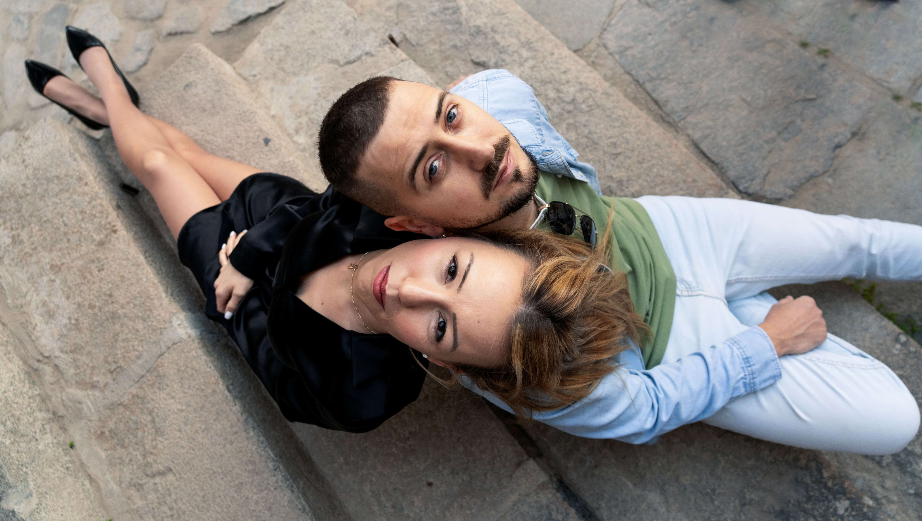 Couple lying on stone steps