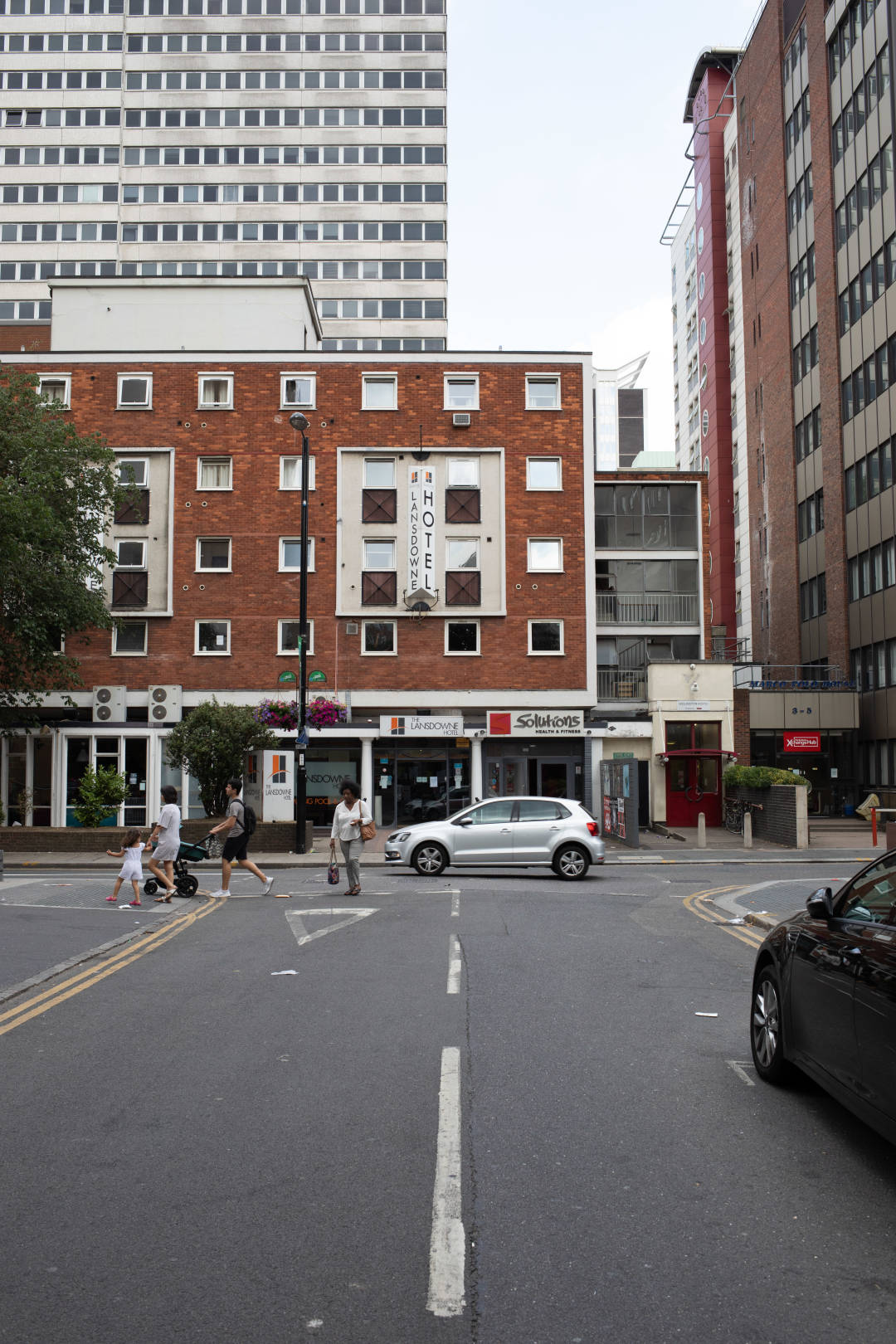 Photo of some 1970s-style buildings at a cross-roads, looking somewhat uncared for