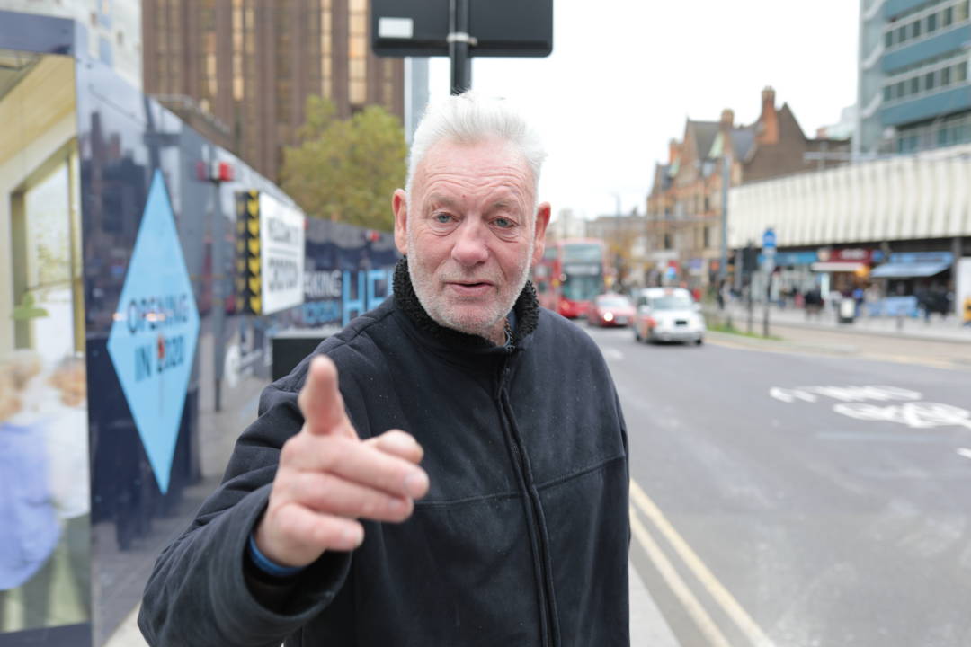 Photo of a man pointing at the photographer of the photo