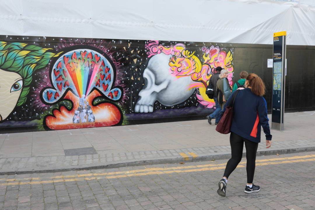 Photo of some colourful artwork painted on a building hoarding