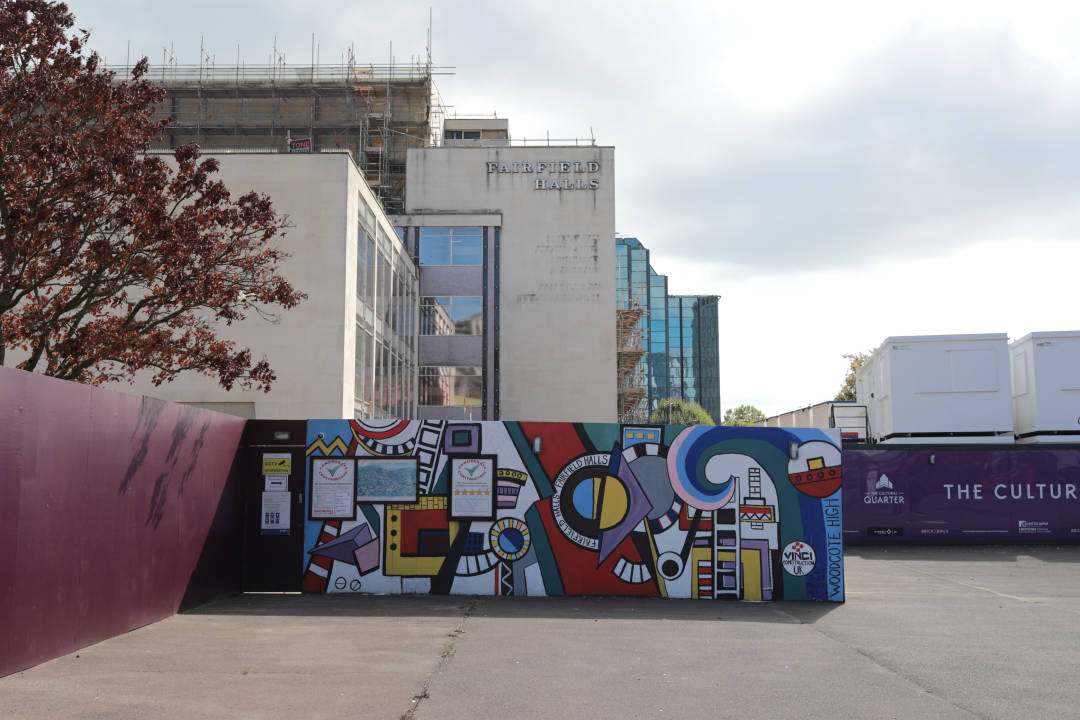 Photo of some artwork painted on a building hoarding