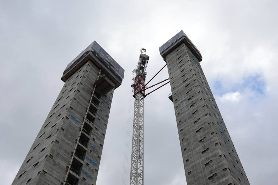 Photo of two tall building cores close up, looking up