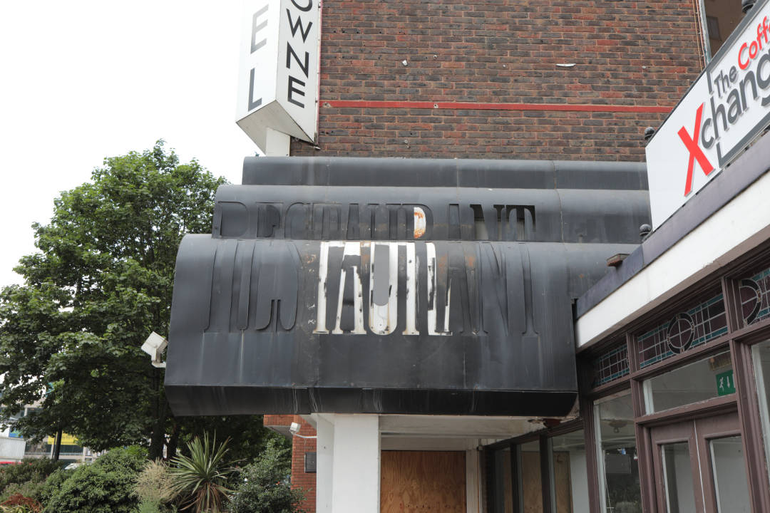 Photo of an old sign on a building saying ‘Restaurant’