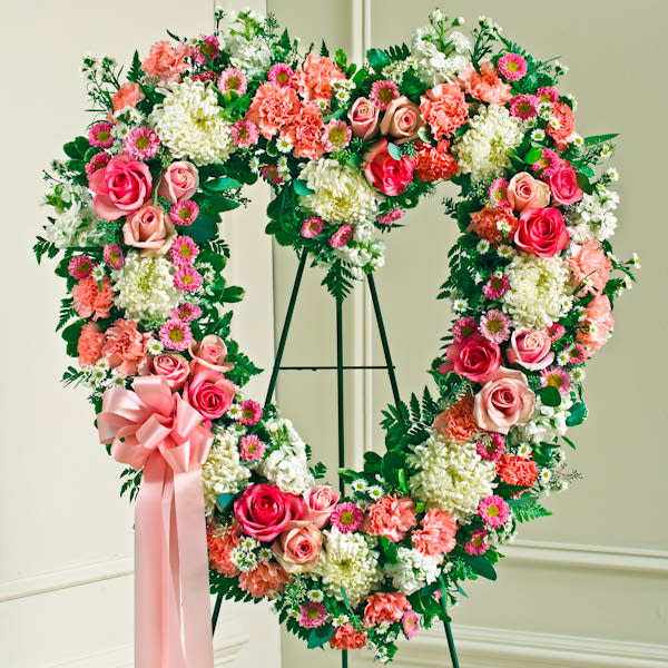 Heart shaped memorial wreath with pink roses and white stocks