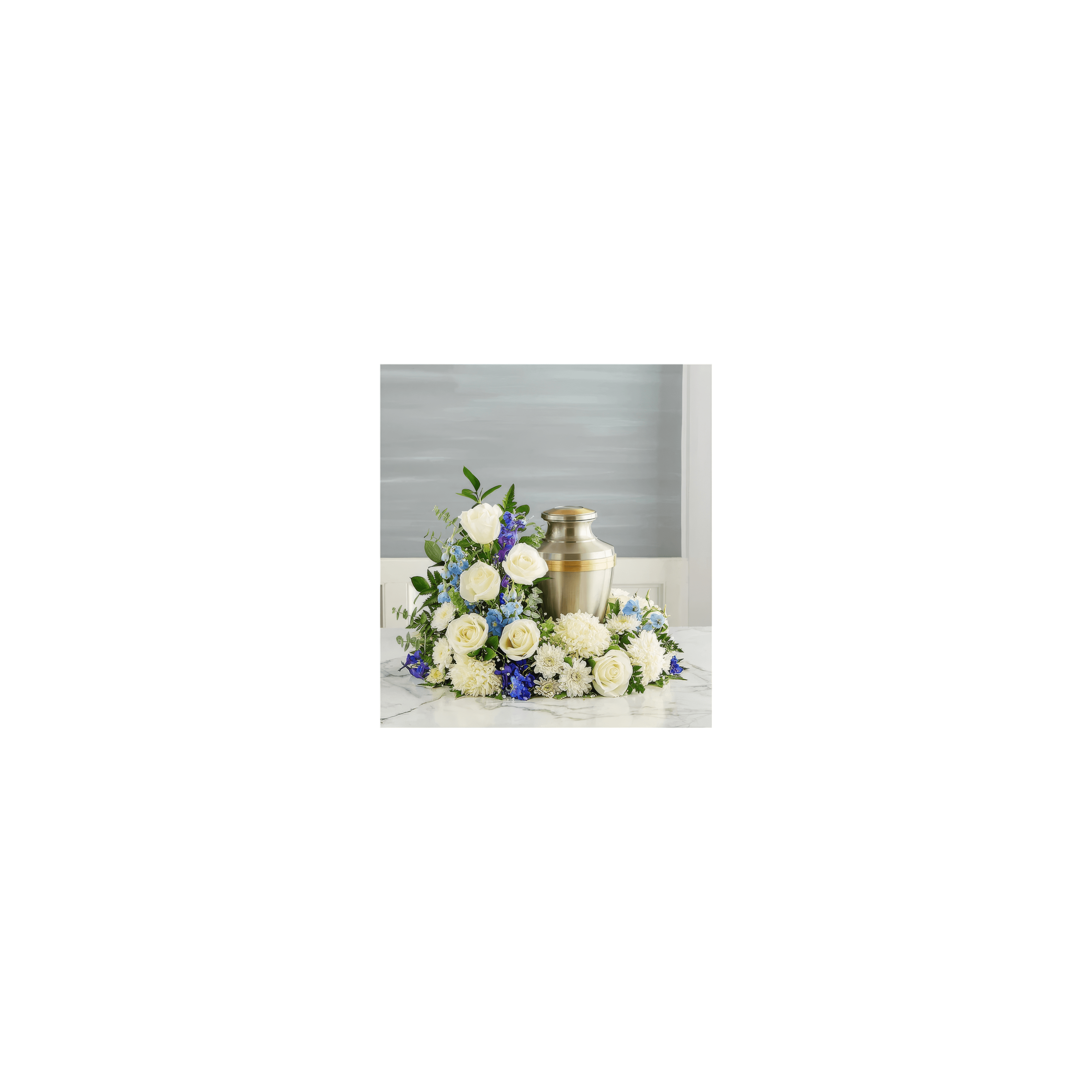 A silver urn is surrounded by white roses and blue flowers arranged beautifully on a marble surface.