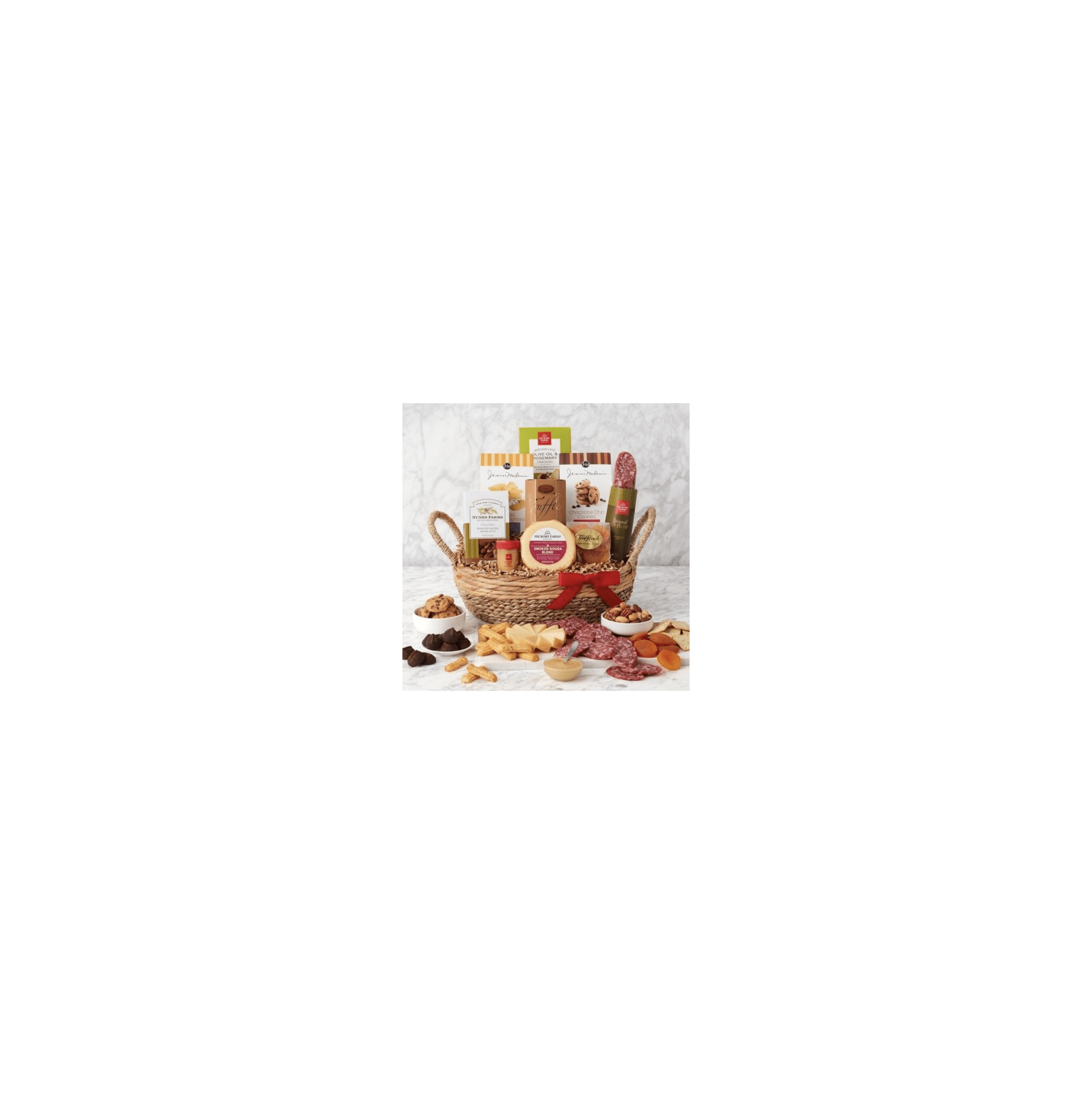A beautifully arranged gift basket features various snacks like cheese, salami, cookies, and nuts.