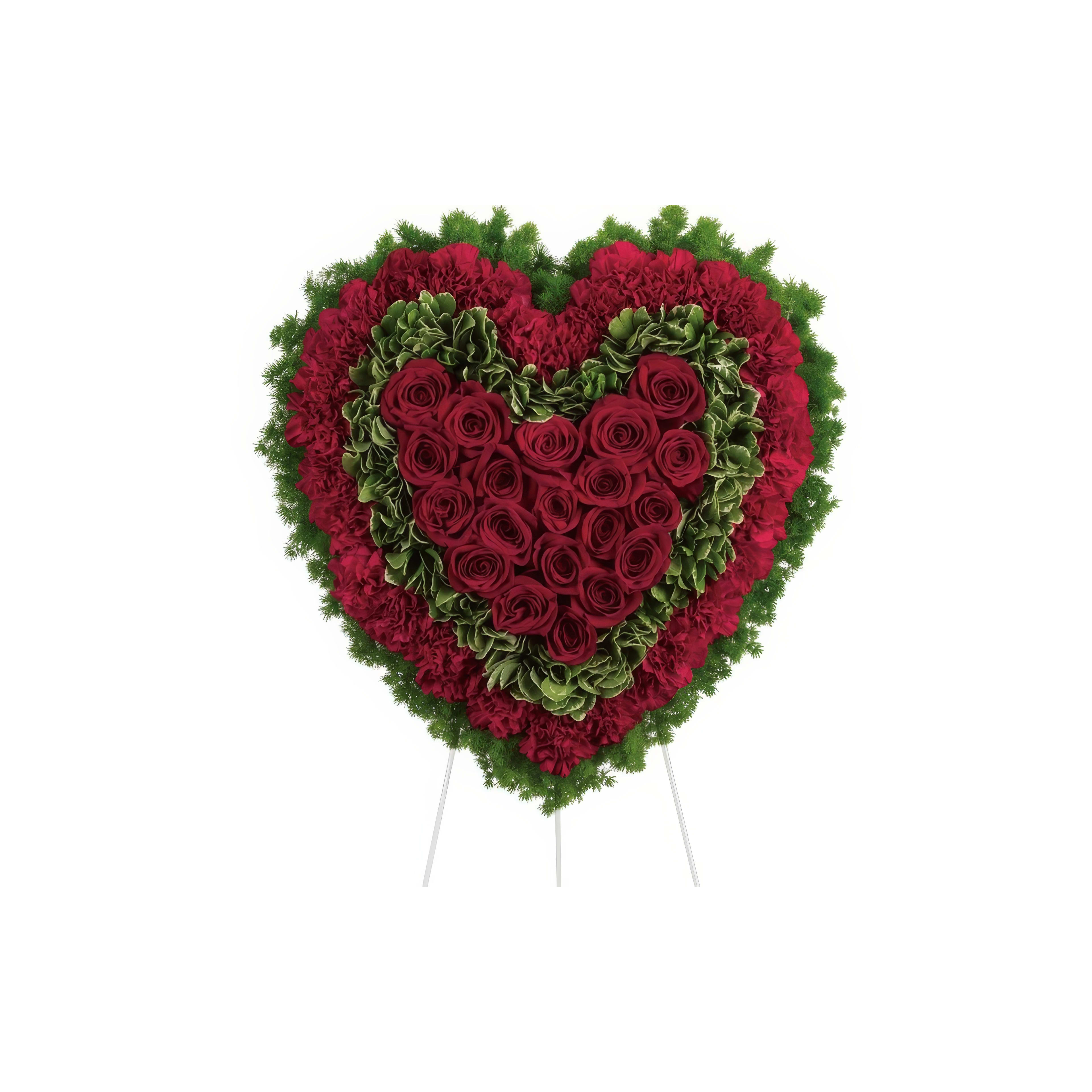 A heart-shaped floral tribute with red roses and green accents, ideal for memorials or celebrations.