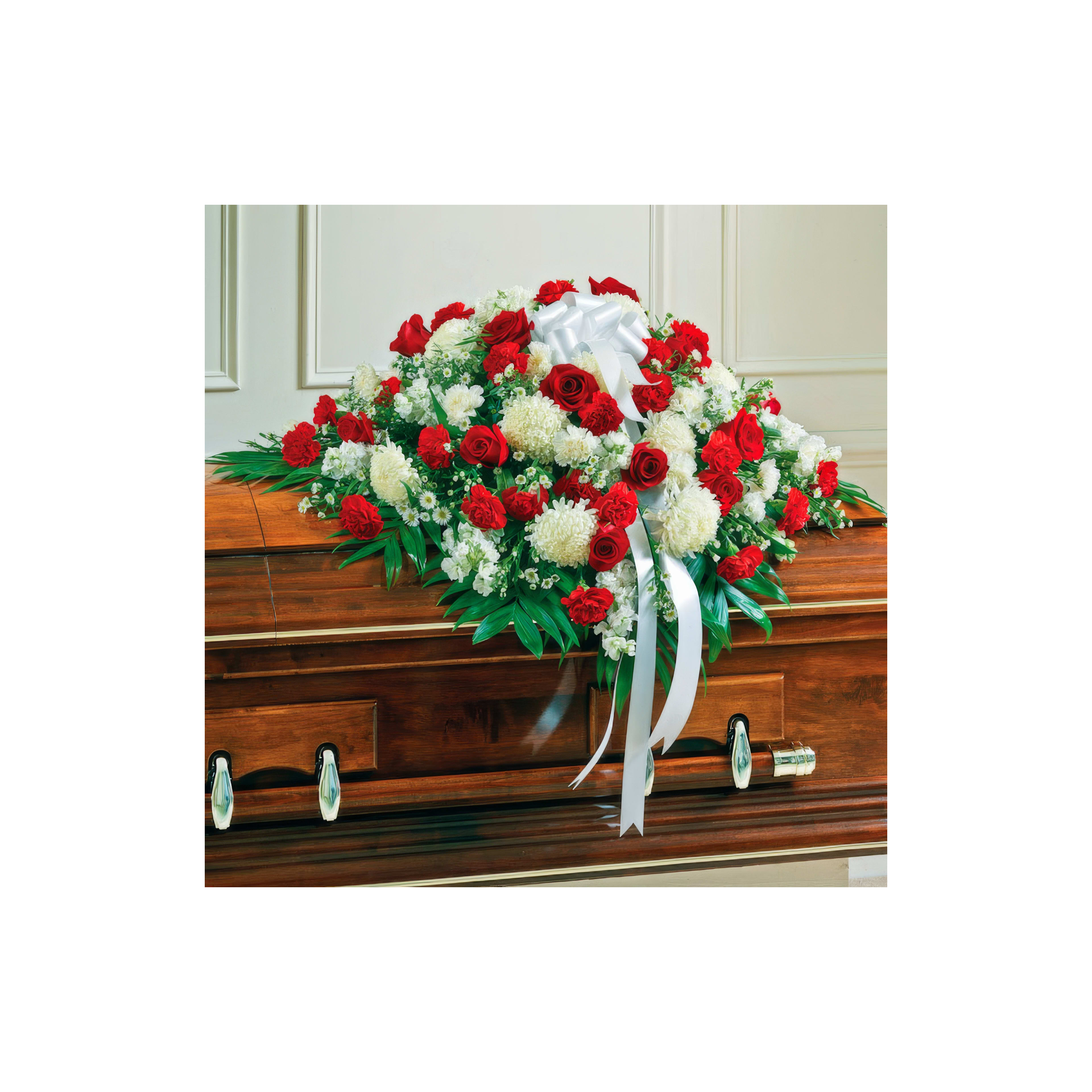 Floral tribute adorned with red and white flowers enhances the solemn atmosphere at a memorial.