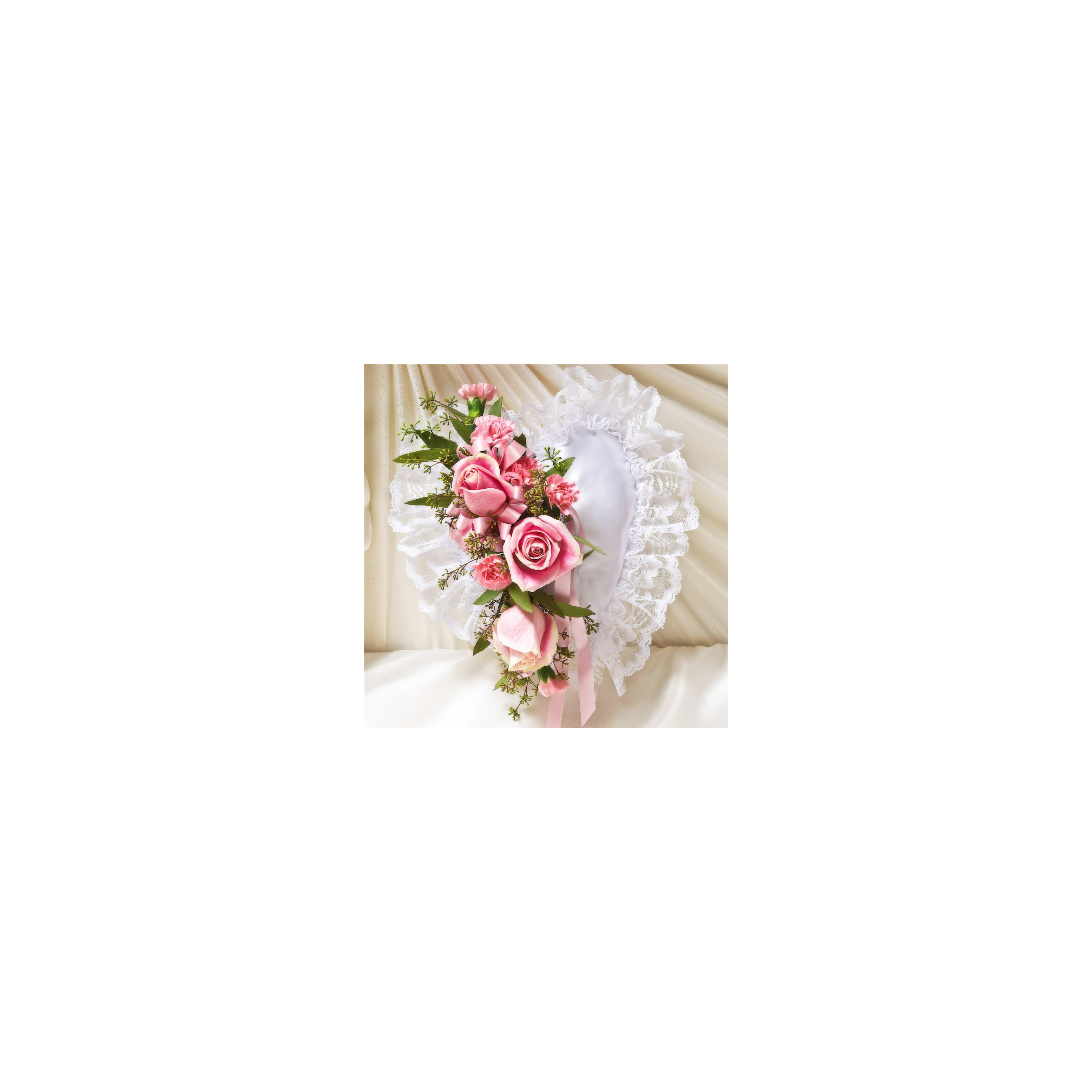 A heart-shaped floral design features pink roses and lace, perfect for weddings or celebrations.